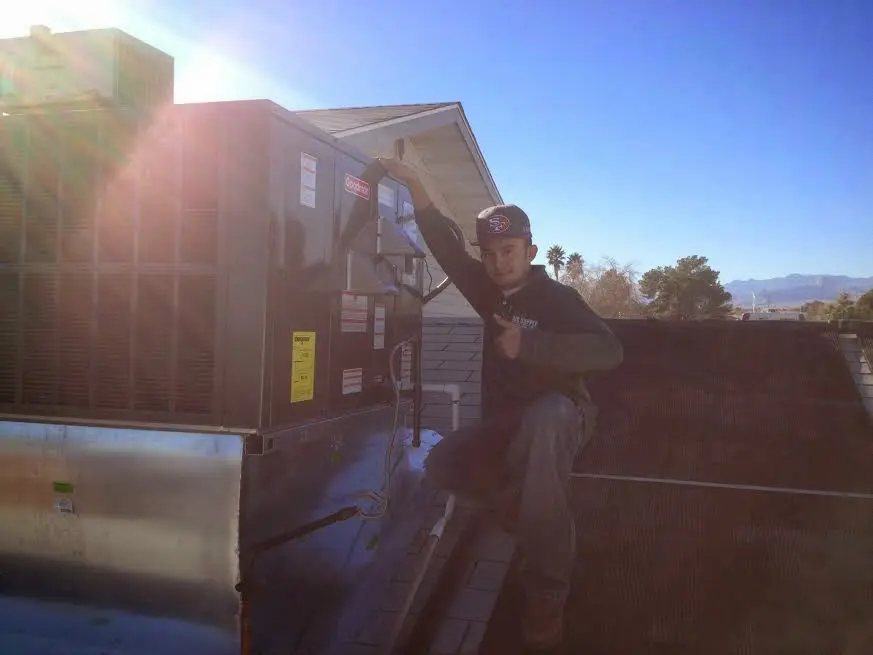 HVAC technician performing Boiler Repair on a rooftop unit in Silverdale